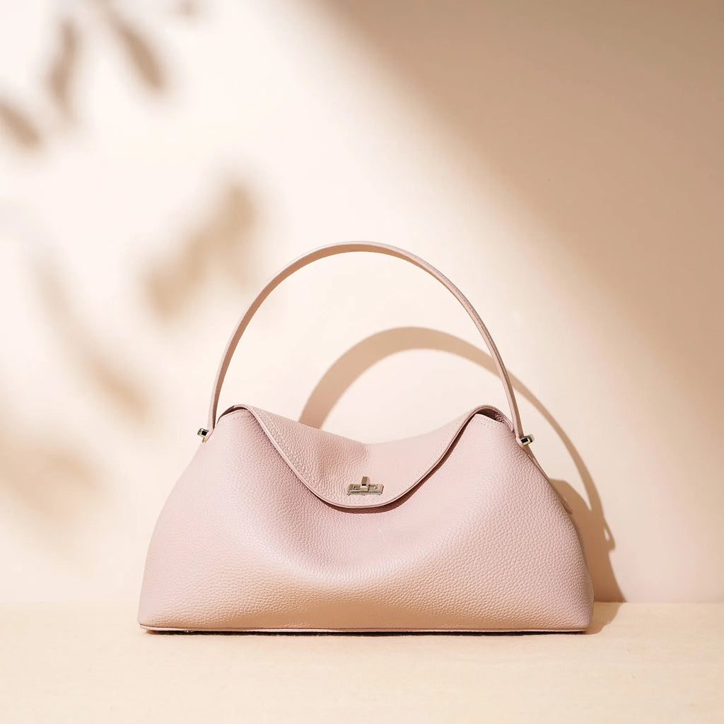 Cowhide leather shoulder messenger bag in a pillow shape with double straps, shown in one of five colour options.