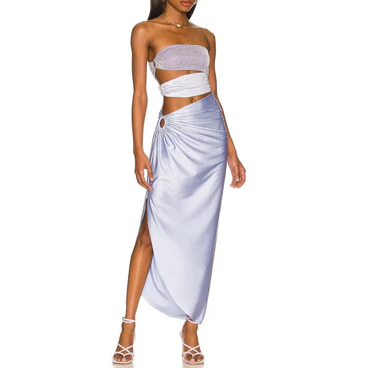 Purple one-piece swimsuit with high-cut legs and a matching wrap skirt laid flat.