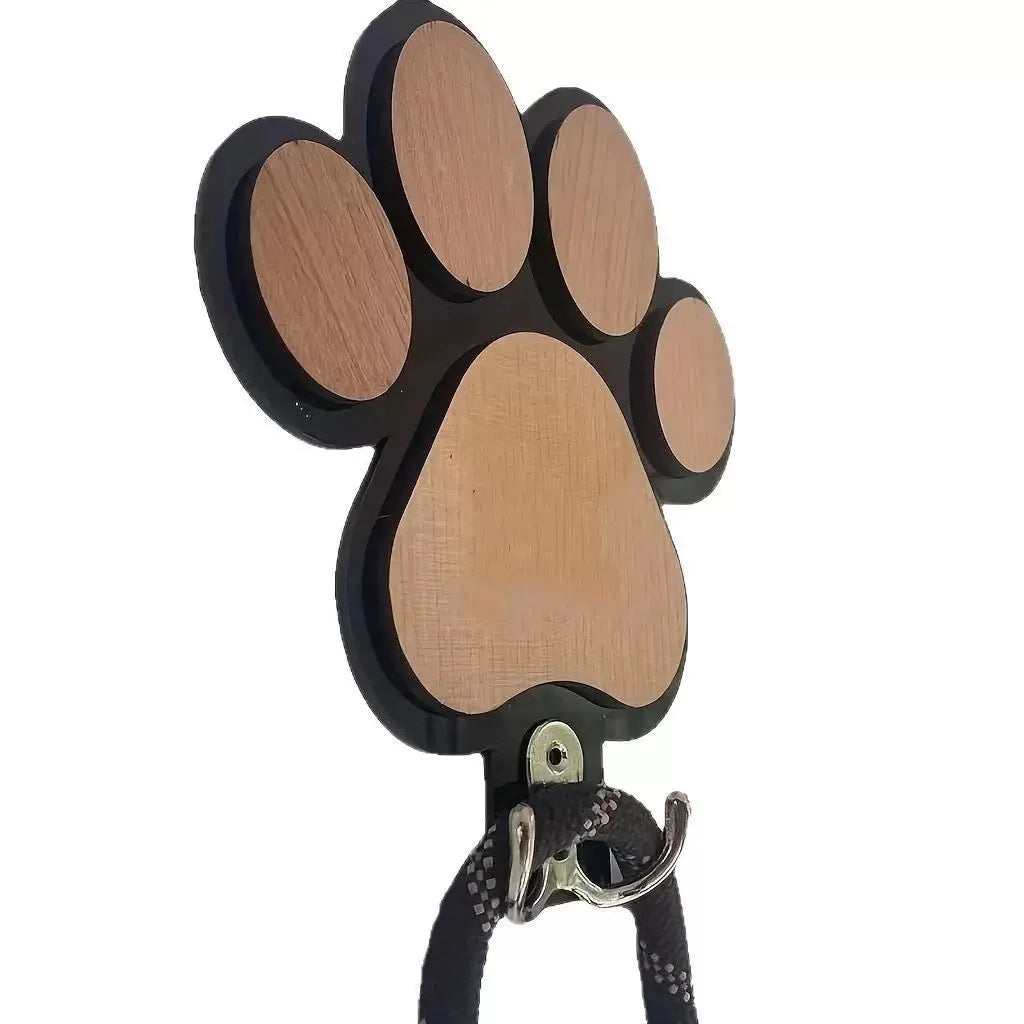 Black wooden wall hook shaped like a paw print for hanging coats and keys