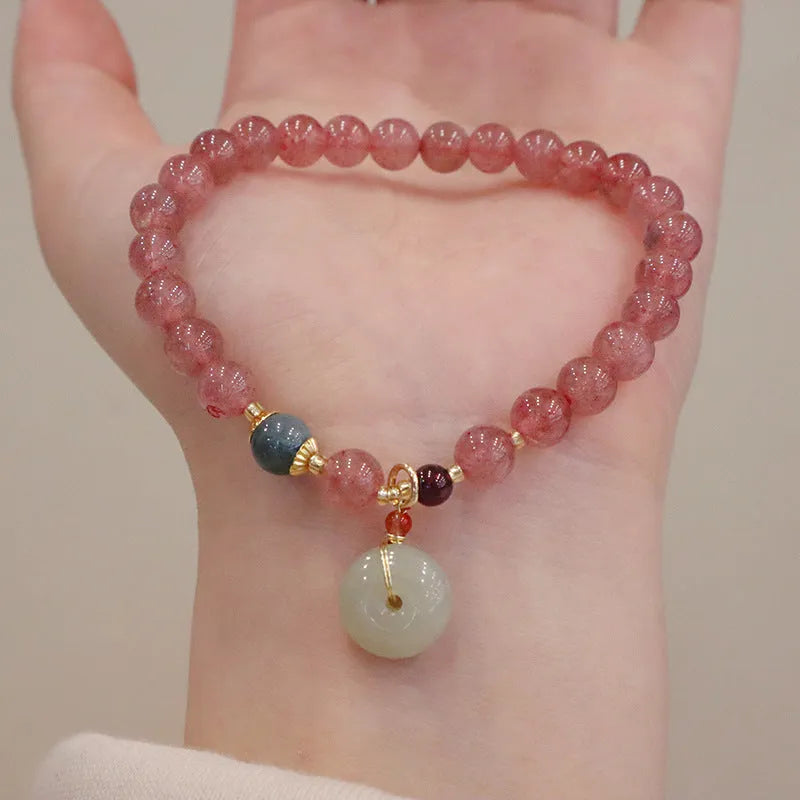 Women's strawberry quartz bracelet with geometric design, purse charm, and safety buckle closure