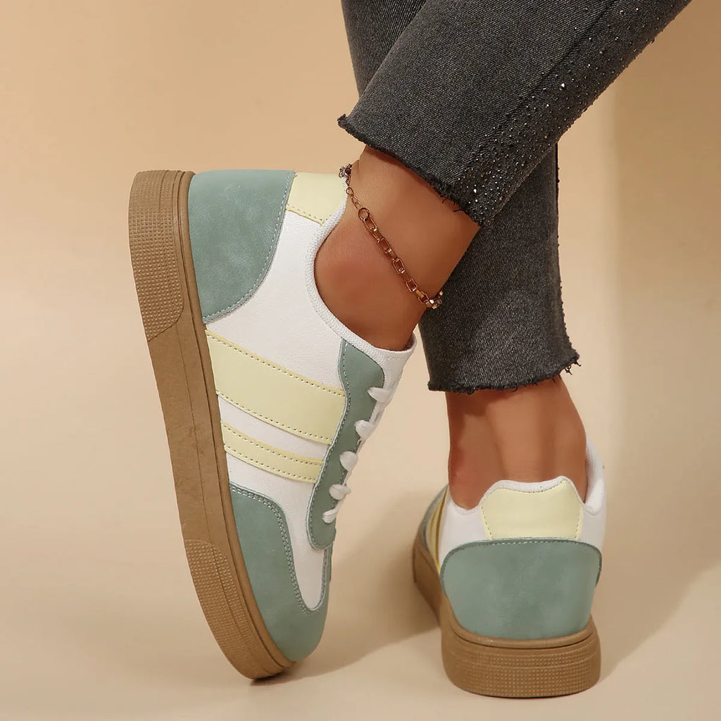 Women's low-top retro sports pumps in a candy colour with cross-strap detail on artificial PU upper.