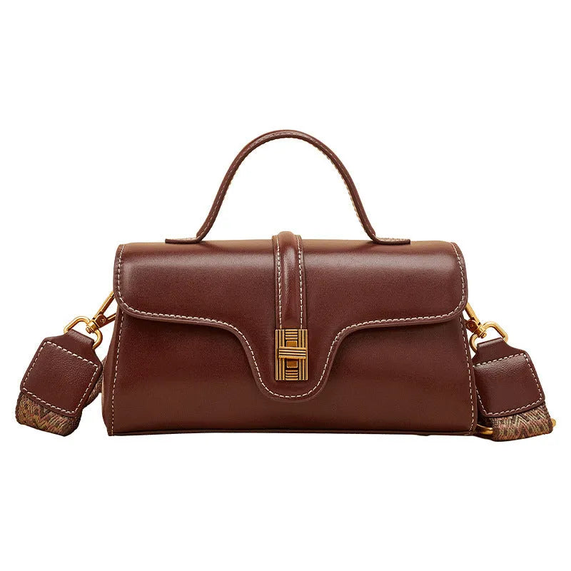 Brown Cambridge-style leather messenger bag with a front lock, shown open to reveal internal zipper pockets.