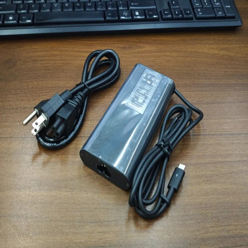 Black 65W USB Type-C laptop power adapter with international travel plug set