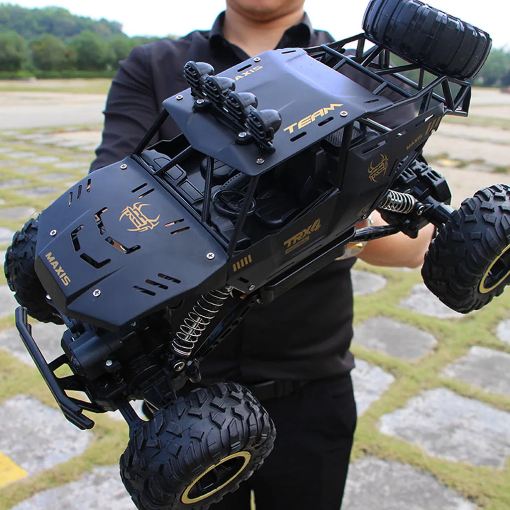 Black or silver remote control climbing car with 2.4G wireless remote on rough terrain