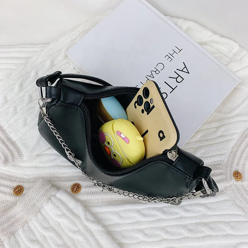 Black butterfly chain underarm bag showing three-dimensional pocket and adjustable metal chain strap