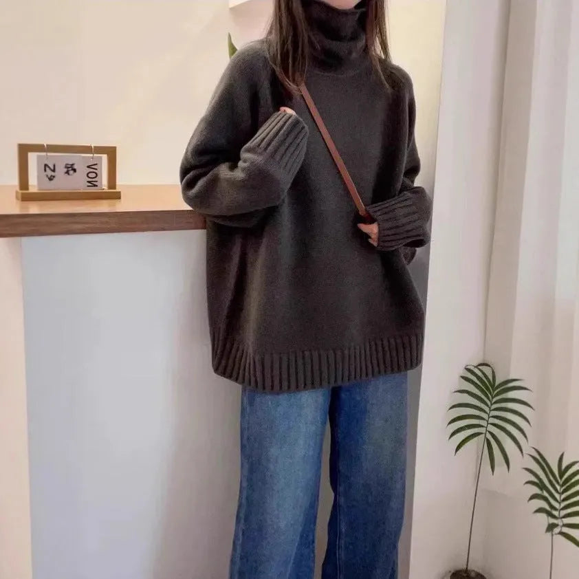 Women's loose-fit grey turtleneck sweater with thick curling pile collar, made of polyester mesh fabric.