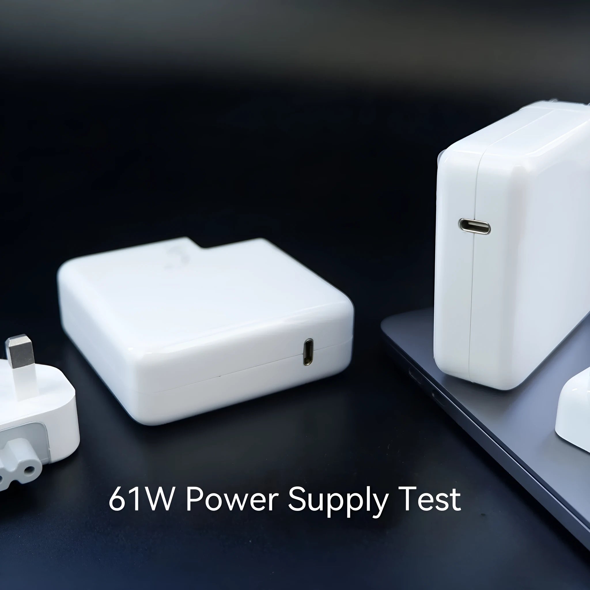 Compact square white laptop USB-C power adapter with optional international plug heads