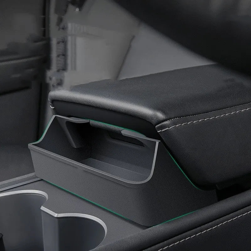 Black silicone sunglasses case installed inside a Tesla Model 3 or Y centre console armrest.