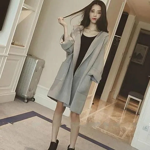 Plus size woman wearing a grey thin cotton coat with lace trim detail and long sleeves.
