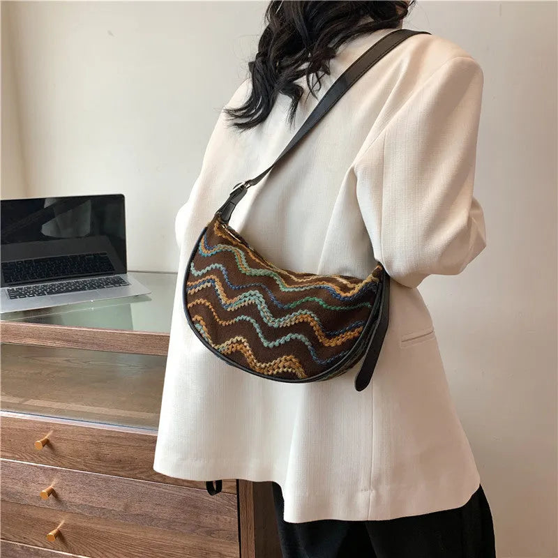 Women's woven straw crossbody bag showing internal phone and file compartments in corrugated brown colour