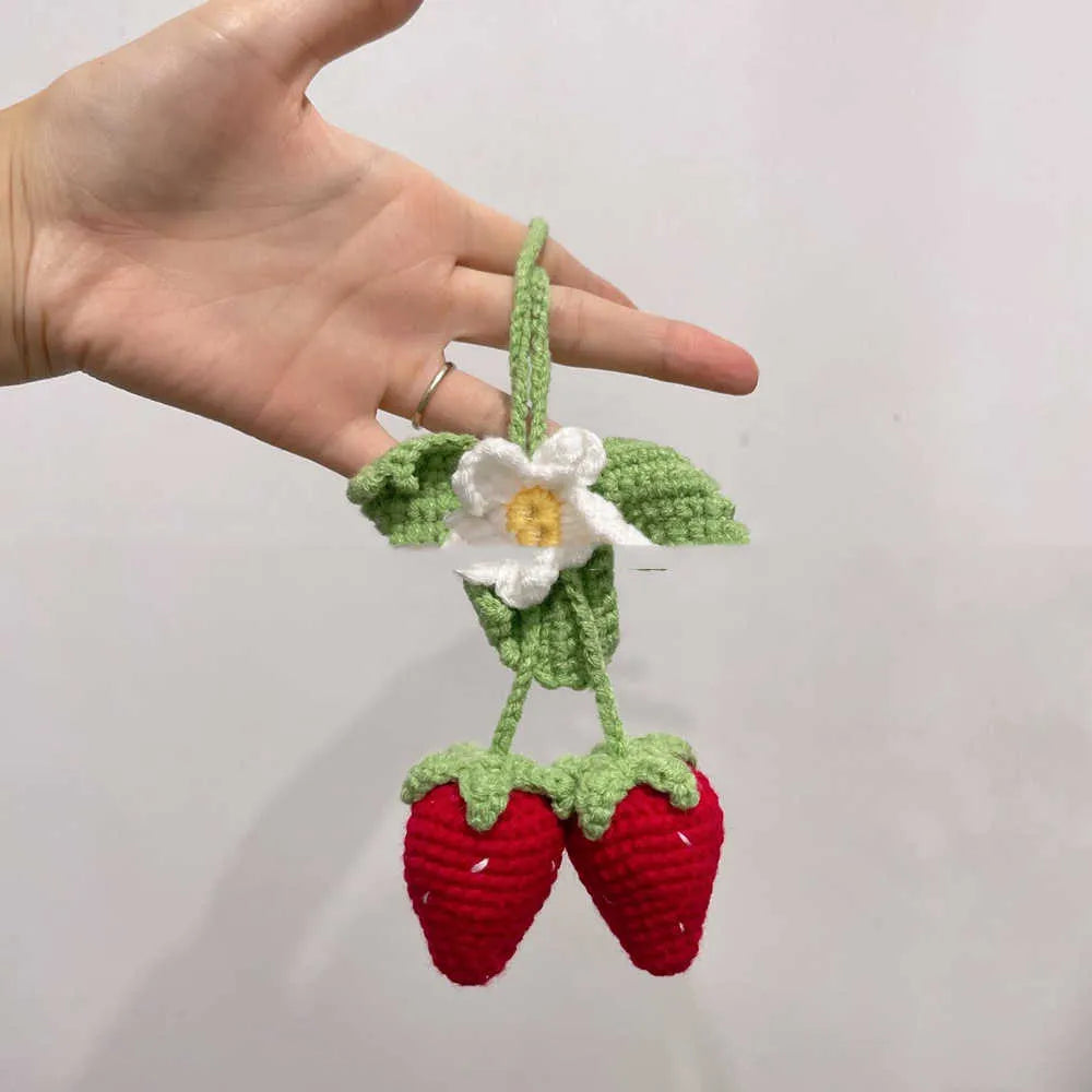 Handmade strawberry weaving car pendant with cotton hemp materials showing detailed stitching