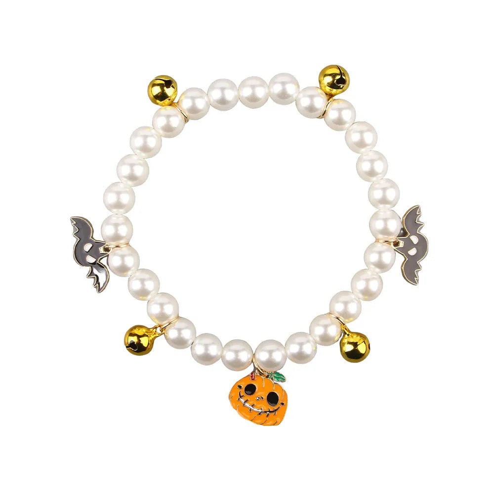 Halloween cat collar with simulated pearls and pumpkin designs in purple ghost, skull, and smiling motifs