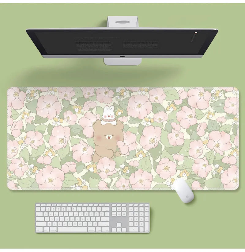 Large rectangular flower pattern mouse pad on a desk with keyboard and mouse.