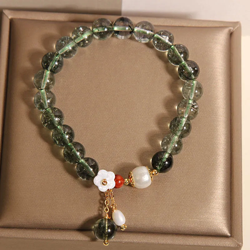 Green phantom quartz crystal bracelet with small bells of Ireland design and shell flower accents