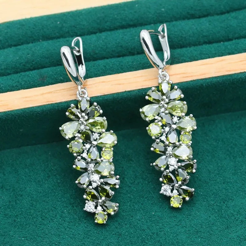 Retro jewellery set with botanical patterns in olive or purple, showing bracelet, necklace, earrings, and ring