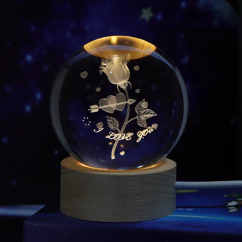 3D crystal ball night light projecting starry sky and planets from its 6cm sphere on a solid wood base.