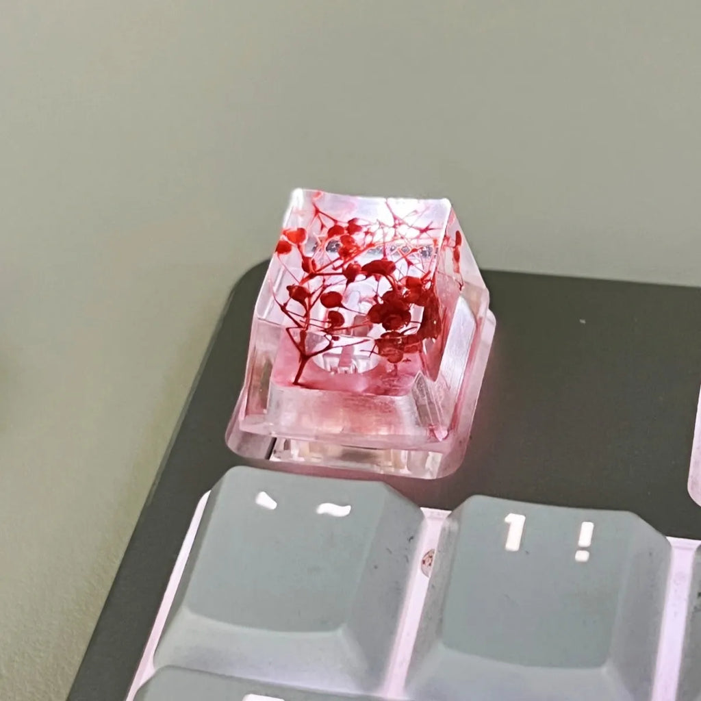 Translucent resin starry sky keycap with glitter particles measuring 1.8cm by 1.2cm