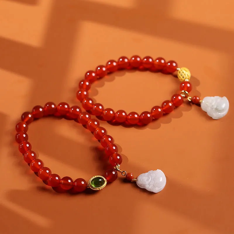 Chinese style geometric women's bracelet with red agate beads and a gold jade Maitreya Buddha pendant.