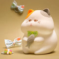 Small yellow Greedy Cat cartoon desktop night light with socket plug on desk.