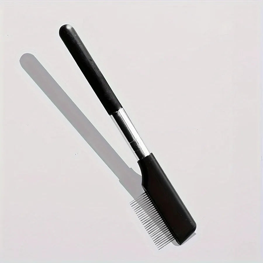 Black ambidextrous pet grooming brush with soft bristles for tear stains and a comb end for hair removal.