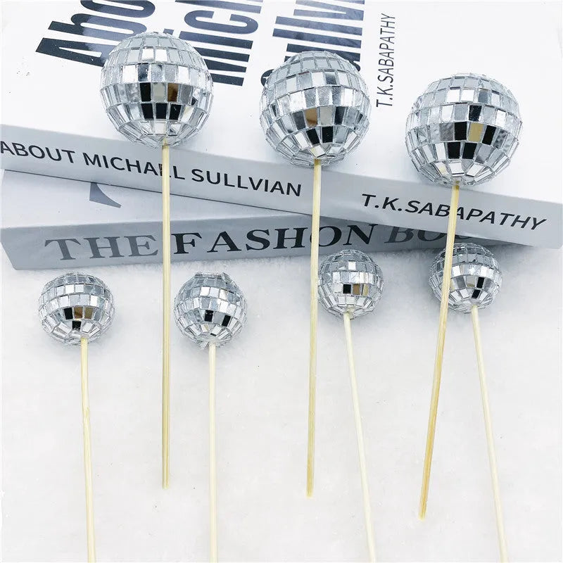 Glass disco ball cake decoration on wooden stick in silver reflective finish