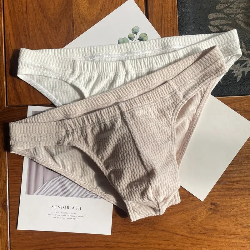 Men's triangle underwear in pure cotton with mid-waist design, available in skin colour, apricot, black, and white variations