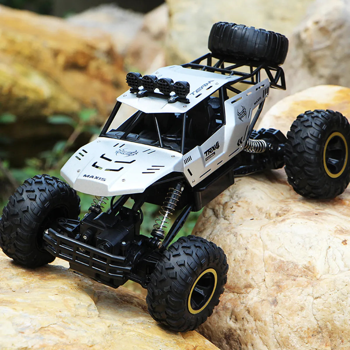 Black or silver remote control climbing car with 2.4G wireless remote on rough terrain