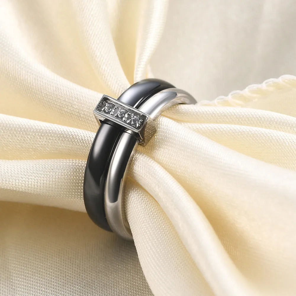Geometric ceramic ring with zirconium inlay, available in steel black or gold white, sizes 6 to 10