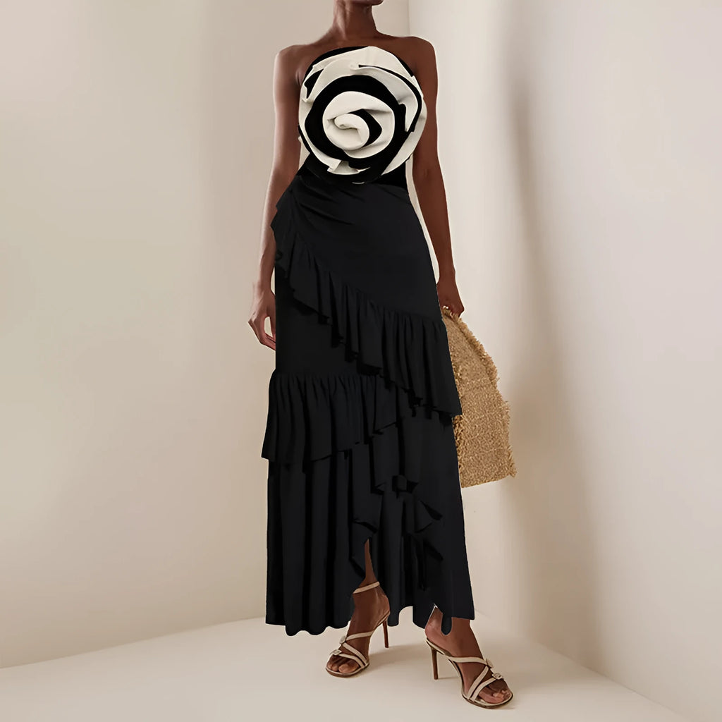 Women's black and white one-piece swimsuit with matching skirt cover-up on beach