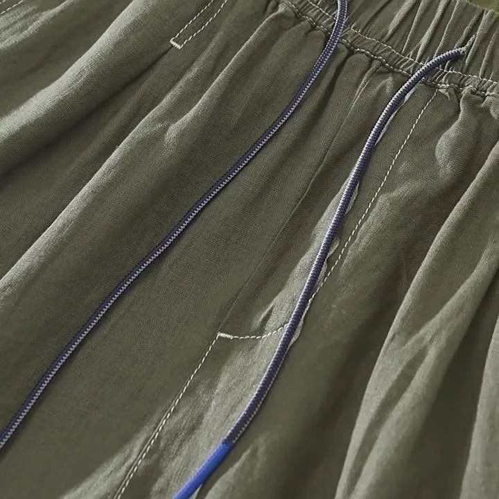 Men's loose straight linen shorts in black or green with drawstring waist