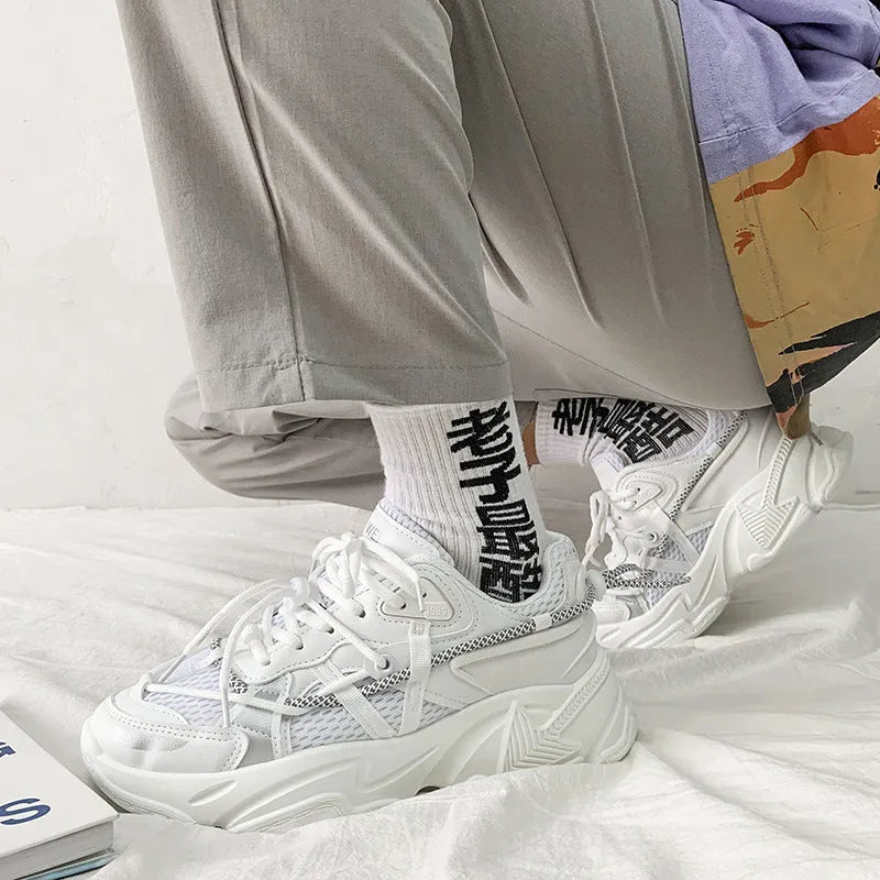 Men's white platform trainers with lace-up front and a breathable mesh lining, shown from the side.