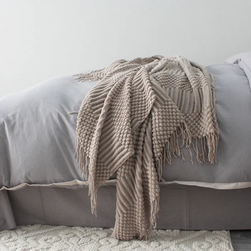 Small grey polyester nap blanket folded to show its texture and size.