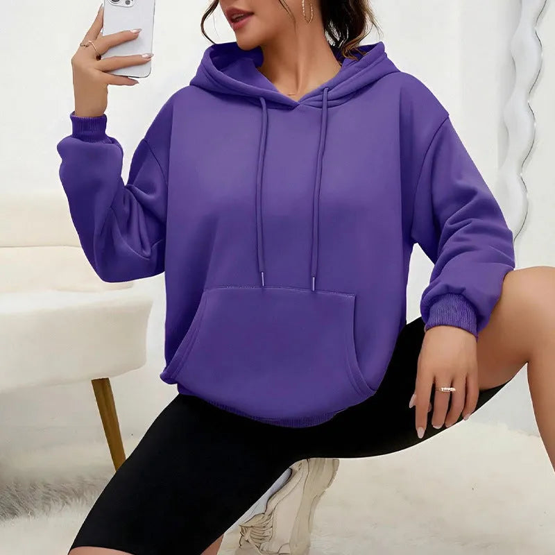 Women's loose grey sweatshirt with long sleeves and a front drawstring pocket, shown in a relaxed fit.