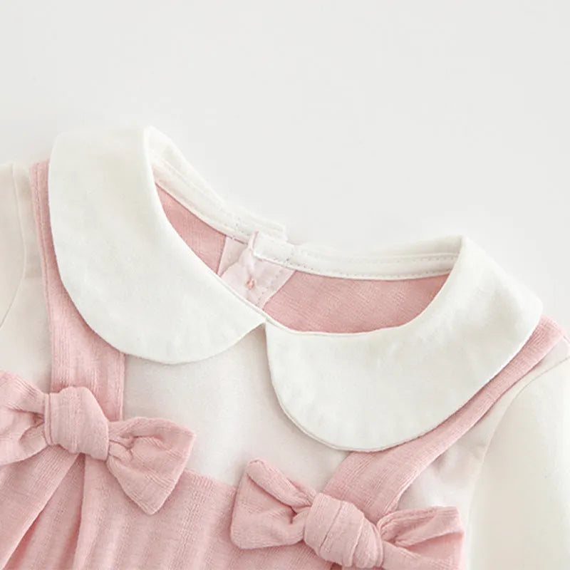 Pink embroidered cotton jumpsuit for baby girl with long sleeves and single-breasted closure