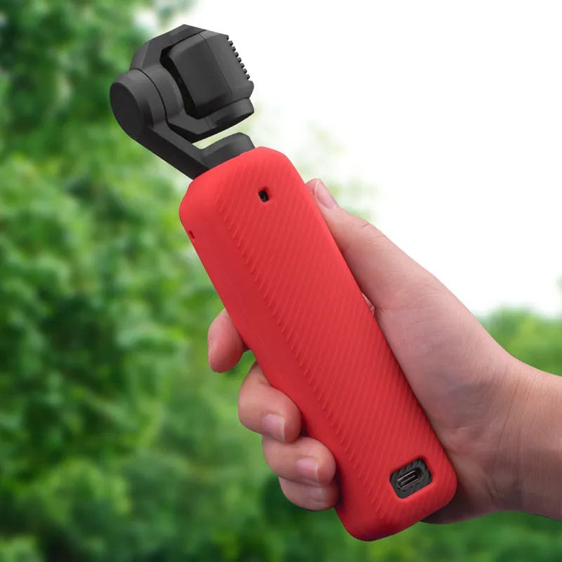 Black silicone protective sleeve for a PTZ camera body, shown alongside red and orange versions.