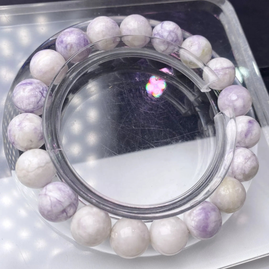 Natural purple turquoise bead bracelet for women on a white background, showing adjustable string tie.