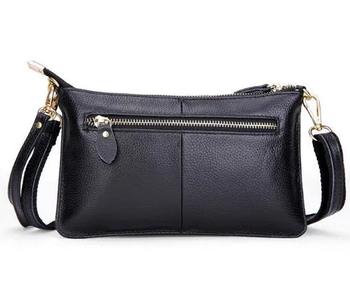 Lady cowhide slant bag showing compact dimensions and multiple compartments for organisation