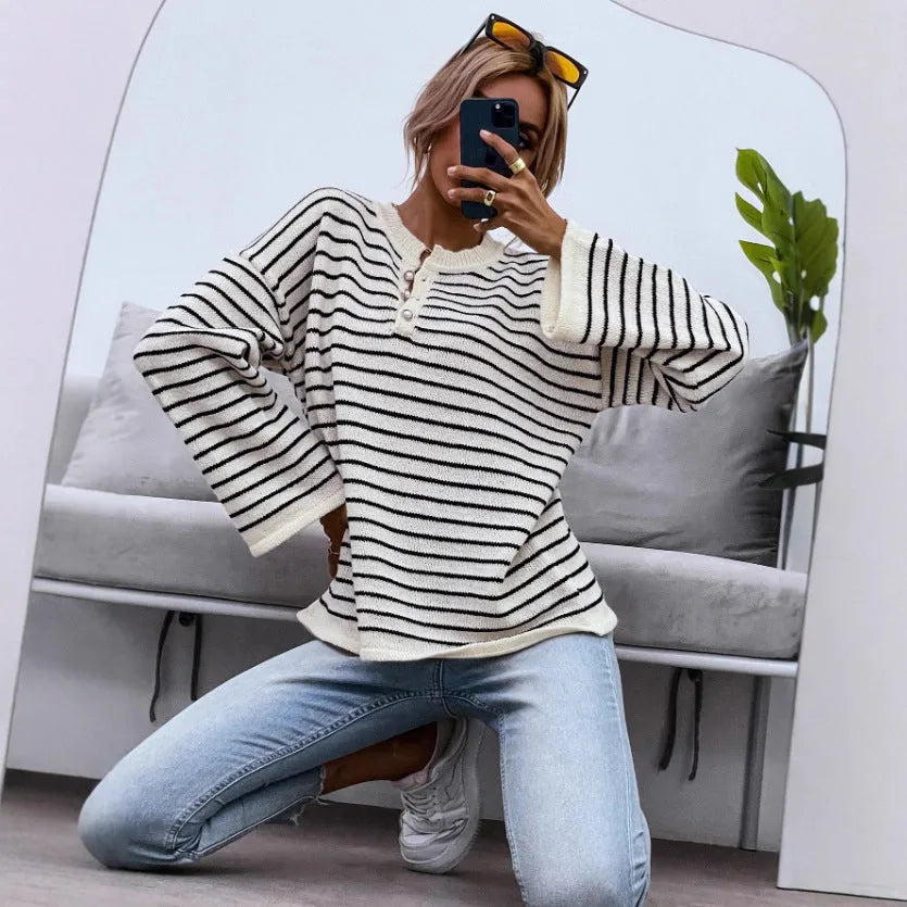 Black and white striped women's long-sleeve viscose top with drop-shoulder sleeves and a button detail.