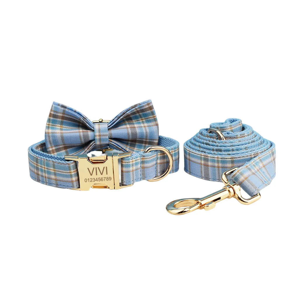 Sky blue and white grid pattern dog collar, leash, bow, and vest four-piece pet accessory set.