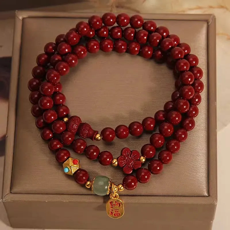 Red cinnabar bracelet with geometric gourd and flower design, 6mm diameter with clasp fastening