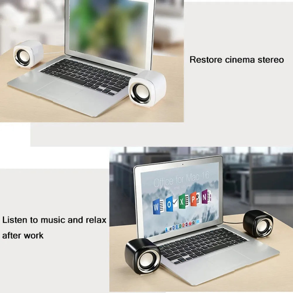 Pair of black wired mini desktop speakers with 3.5mm plug, showing compact cubic shape.