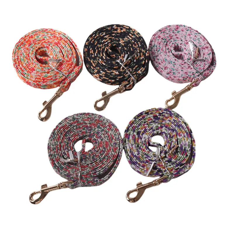 Floral pattern cloth dog harness and leash set shown in small size on a model.