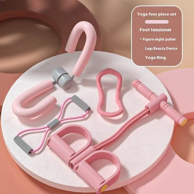 Yoga four piece set with leg stretching device, yoga ring, pedal tensioner, and figure eight tension rope on a mat