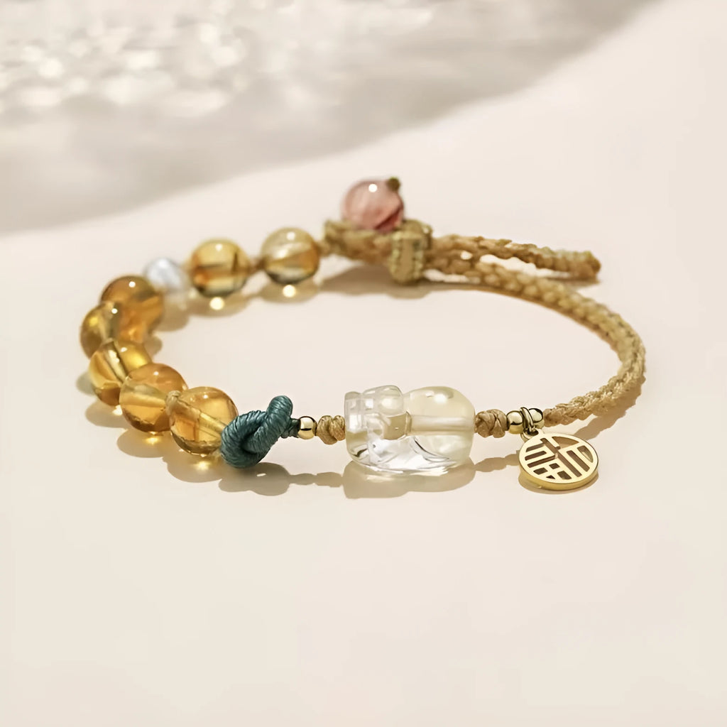 Hand-woven crystal bracelet with animal zodiac design in citrine colour
