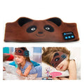Black Bluetooth sleep mask with small built-in earphones nestled in soft grey padding.
