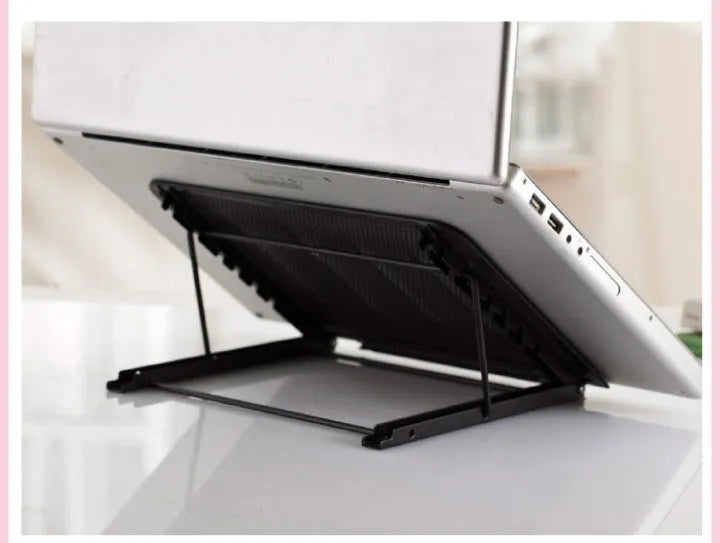 Folded metal laptop stand in silver colour showing slim 1.5cm profile next to a laptop.