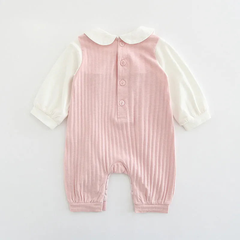 Pink embroidered cotton jumpsuit for baby girl with long sleeves and single-breasted closure