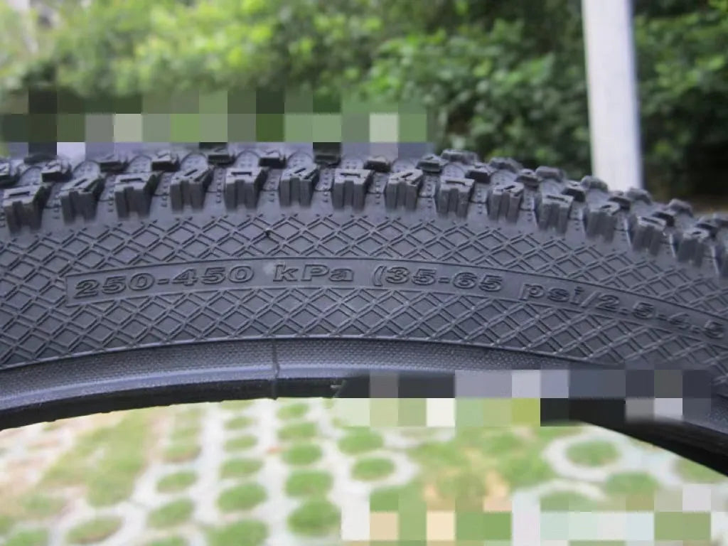Mountain bike tyre showing tread pattern and sidewall with size markings