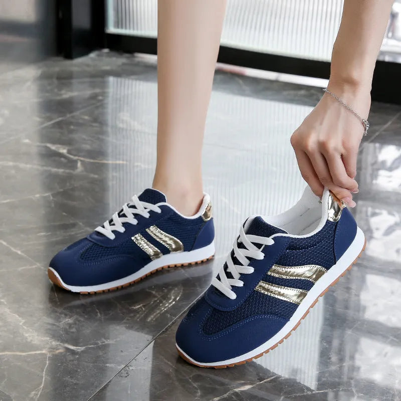 Blue women's lace-up casual sports shoes with cross straps and a flat rubber sole.