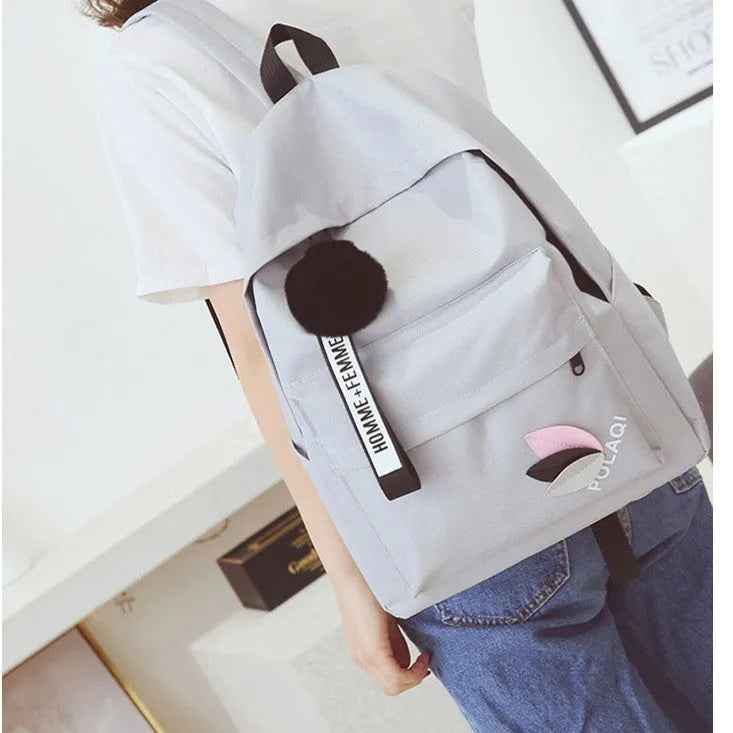Casual canvas college schoolbag with leaf pattern in green, shown with size and anti-theft features.